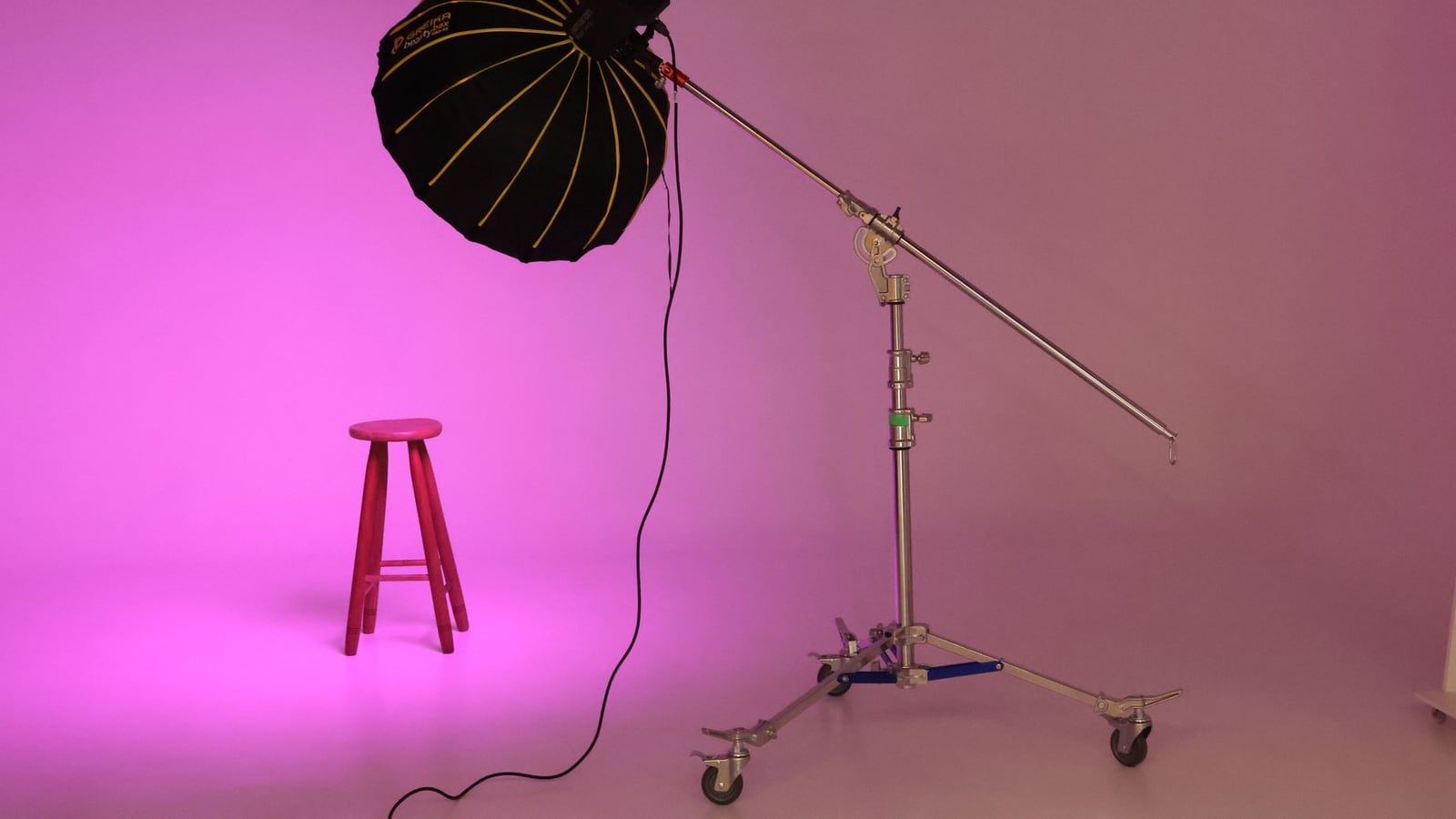 Interior of a professional photo studio with a white cyclorama wall and soft lighting