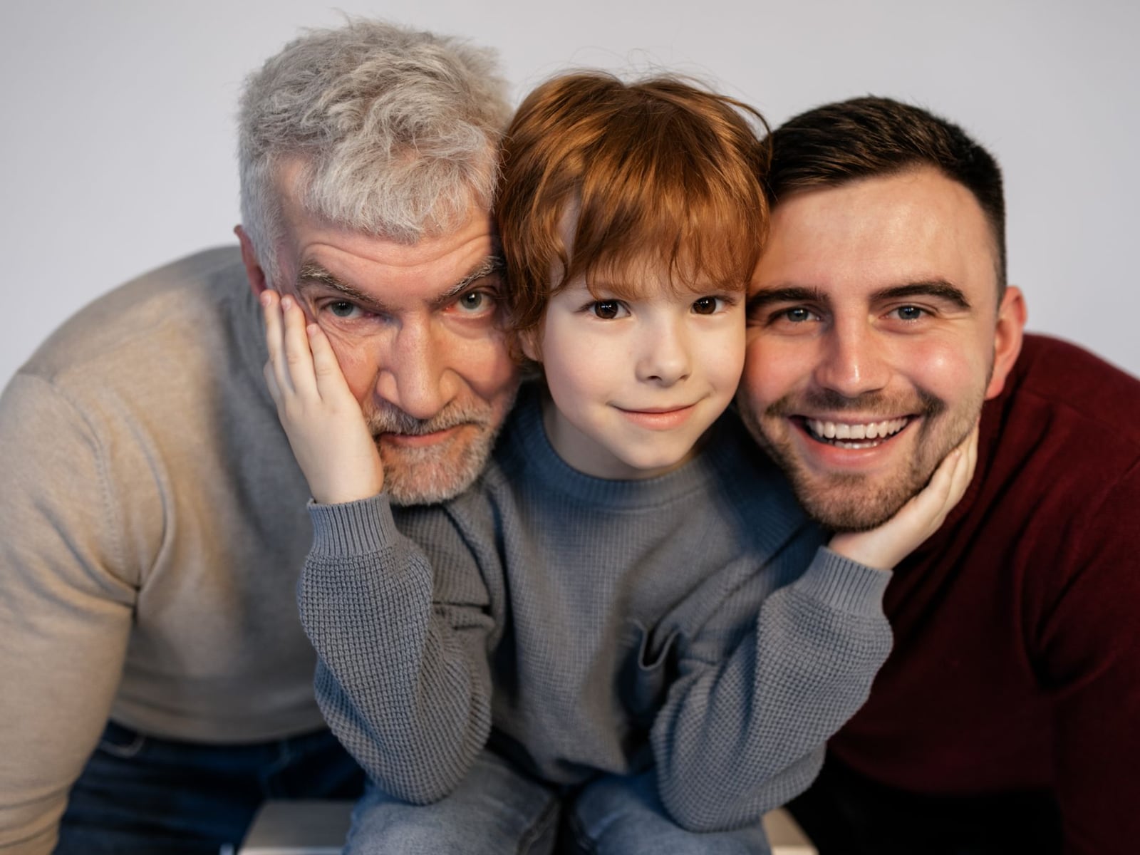 A happy young family laughing together during a studio photo session